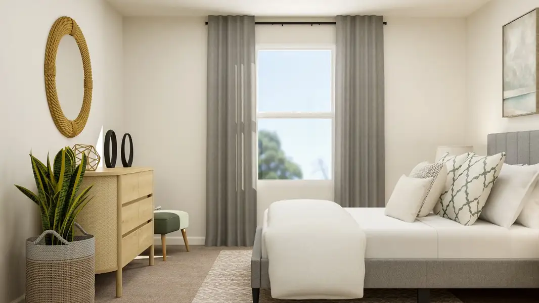 A living room with a white couch and a white chair.