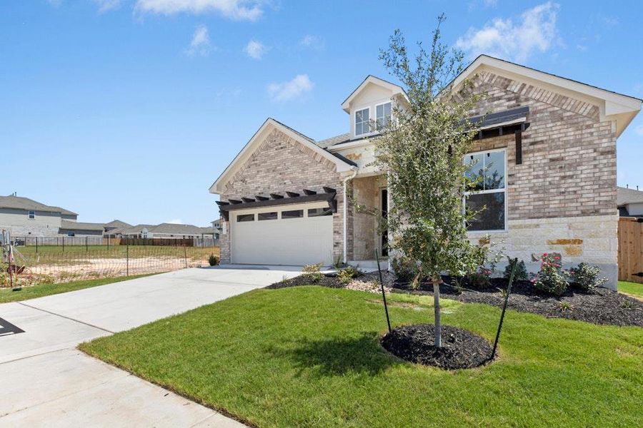 Front exterior of a new home in University Heights, Round Rock, TX, highlighting curb appeal (Image 16).