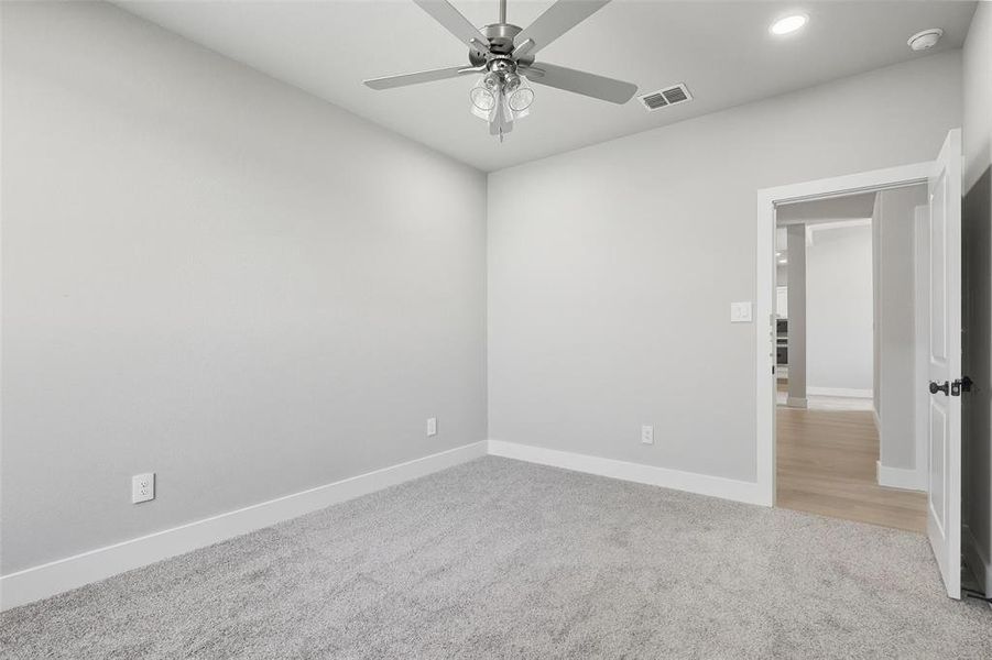 Spare room featuring light carpet, recessed lighting, and ceiling fan Spare room featuring light carpet, recessed lighting, and ceiling fan