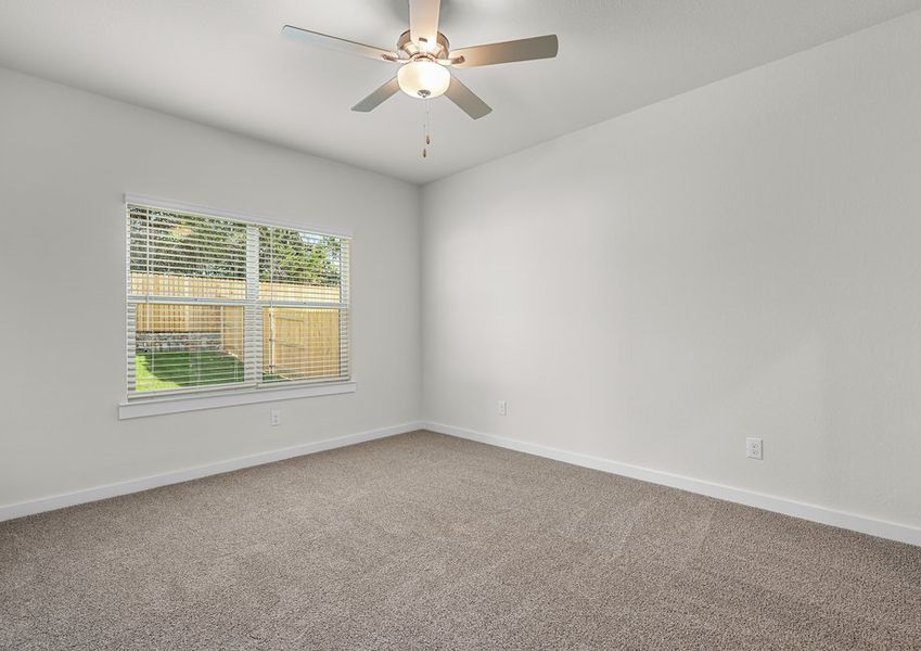 The spacious master bedroom has a window that lets in great, natural light and backyard views.