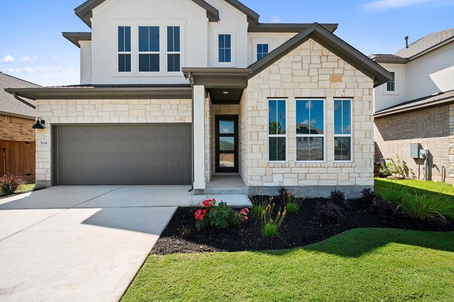 Front exterior of a new home in Lariat, Liberty Hill, TX, highlighting curb appeal (Image 22). Front exterior of a new home in Lariat, Liberty Hill, TX, highlighting curb appeal (Image 22).