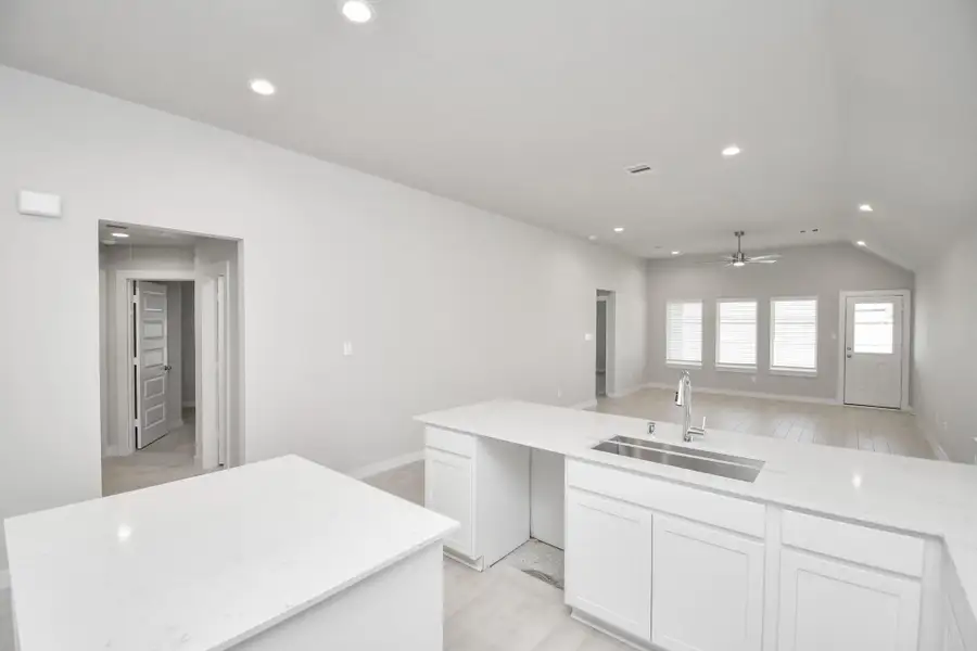 Discover another perspective of this stunning kitchen, generously appointed with an abundance of counter space. Sample photo of completed home with similar floor plan. Actual colors and selections may vary. Discover another perspective of this stunning kitchen, generously appointed with an abundance of counter space. Sample photo of completed home with similar floor plan. Actual colors and selections may vary.