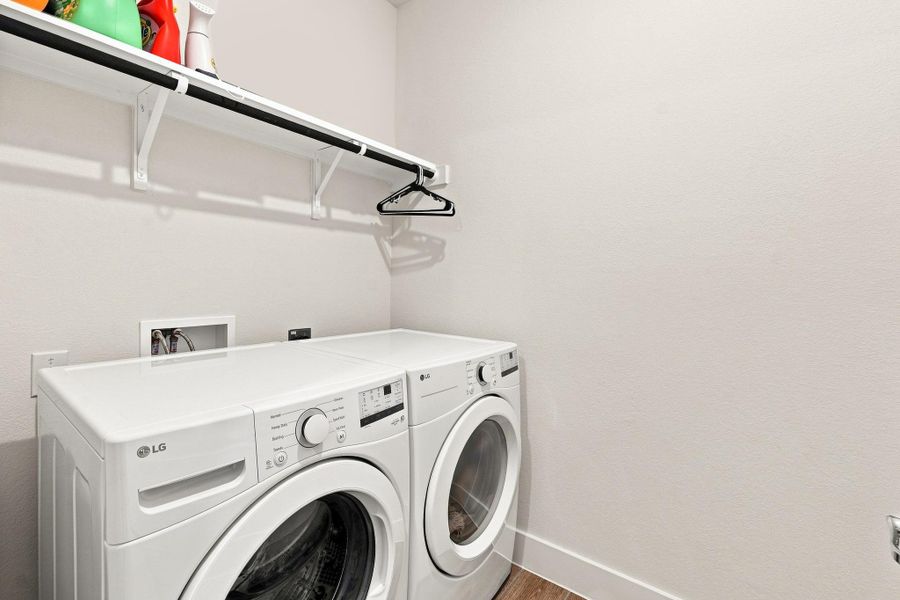 Utility room featuring Level 6 wood-plank tile flooring, upper storage shelving, Washer and Dryer. Utility room featuring Level 6 wood-plank tile flooring, upper storage shelving, Washer and Dryer.