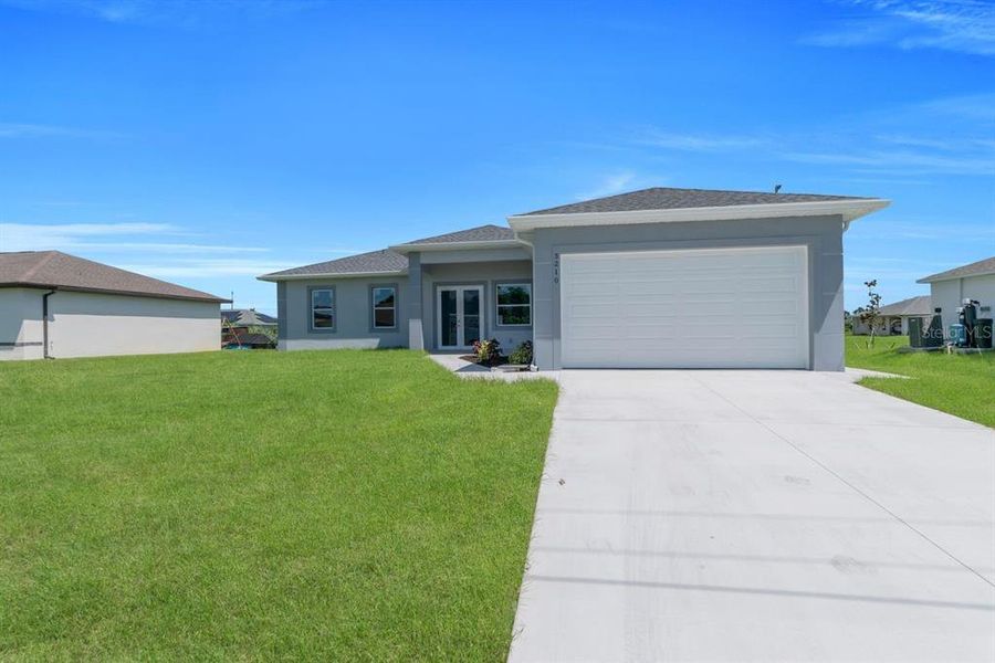 Front exterior of a new home in , Lehigh Acres, FL, highlighting curb appeal (Image 17). Front exterior of a new home in , Lehigh Acres, FL, highlighting curb appeal (Image 17).