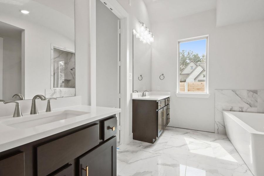 Full bath with marble finish floor, a sink, a freestanding tub, and two vanities Full bath with marble finish floor, a sink, a freestanding tub, and two vanities
