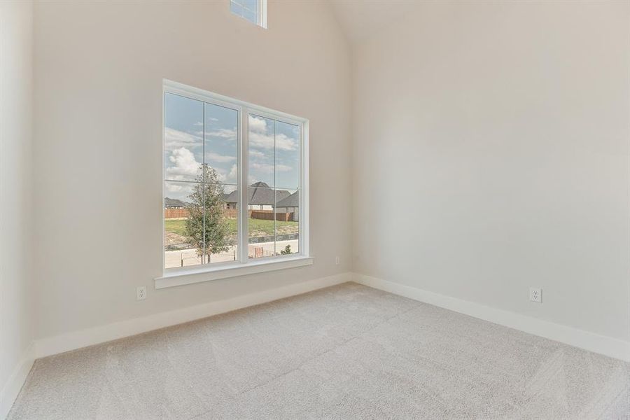 Spare room with carpet and plenty of natural light Spare room with carpet and plenty of natural light