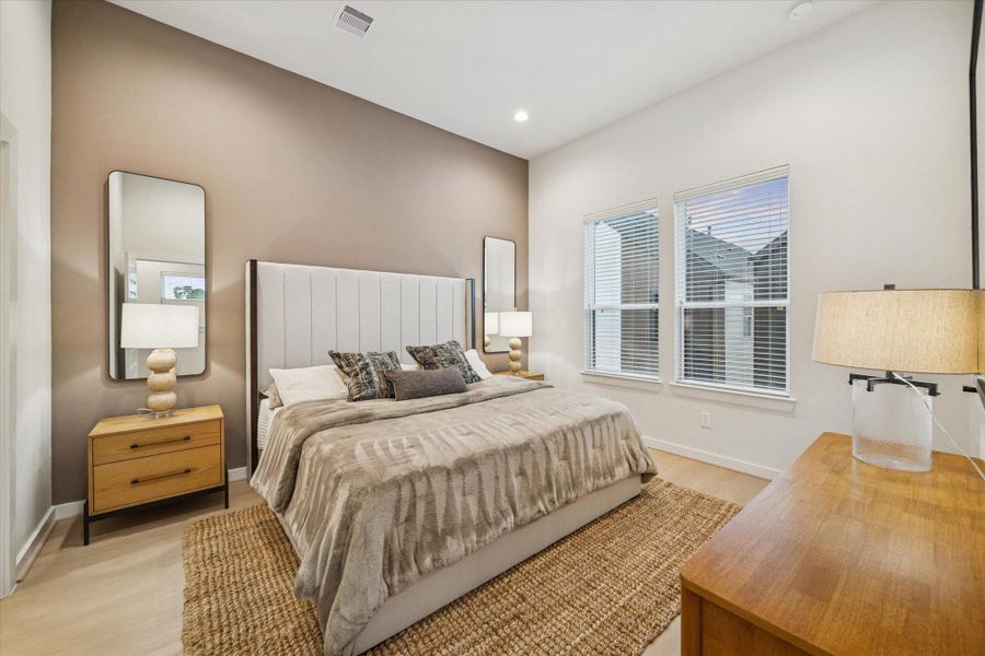 Inviting bedroom with warm tones, tall ceilings, and abundant natural light. The accent wall adds depth, creating a relaxing retreat that balances comfort and sophistication. Inviting bedroom with warm tones, tall ceilings, and abundant natural light. The accent wall adds depth, creating a relaxing retreat that balances comfort and sophistication.