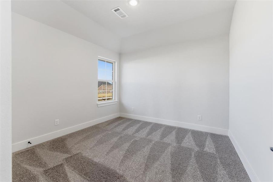 Carpeted empty room with baseboards and recessed lighting