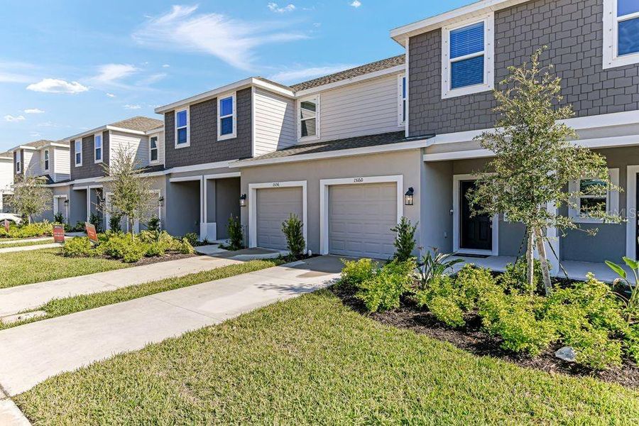 Front exterior of a new home in Vinterra Townhomes, Nokomis, FL, highlighting curb appeal (Image 2). Front exterior of a new home in Vinterra Townhomes, Nokomis, FL, highlighting curb appeal (Image 2).