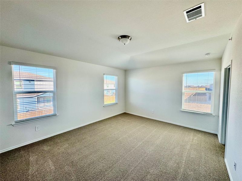 Carpeted spare room with baseboards
