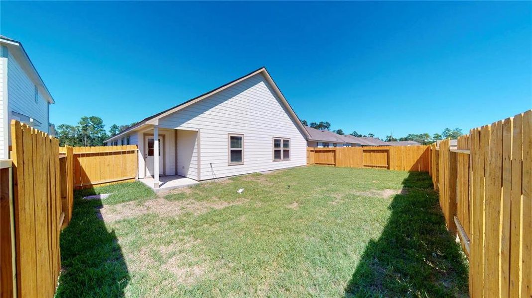 The fenced backyard offers a secure and private outdoor space, ideal for children, pets, or gardening. The covered patio provides a shaded area for relaxing or entertaining. This is a picture of an Elise Floor Plan with another Saratoga Homes.