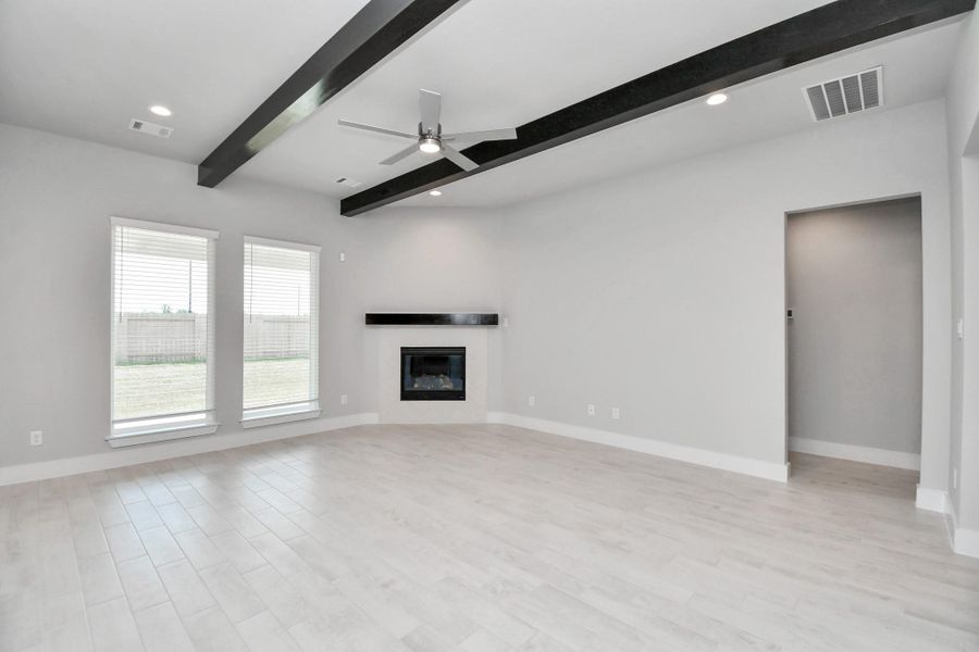 Family room flooded with natural light through the expansive windows. The premium tile flooring adds a touch of luxury to the space, creating the perfect setting for relaxing moments and cherished gatherings with loved ones. Sample photo of completed home with similar floor plan. Actual colors and selections may vary. Family room flooded with natural light through the expansive windows. The premium tile flooring adds a touch of luxury to the space, creating the perfect setting for relaxing moments and cherished gatherings with loved ones. Sample photo of completed home with similar floor plan. Actual colors and selections may vary.