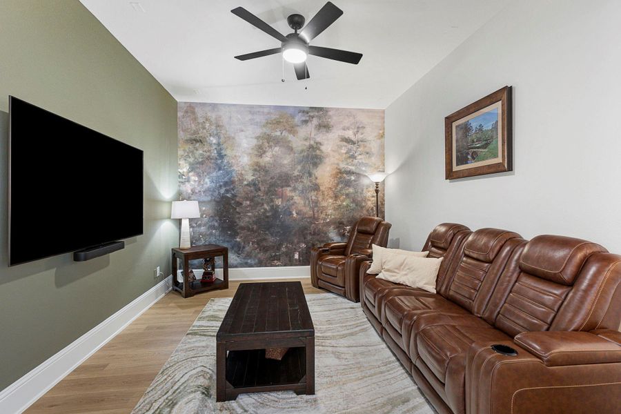 The media room showcases an accent wall and a comfortable layout designed for entertainment!