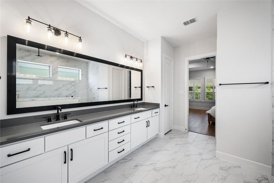 Dual sinks, linen closet and lots of storage space.