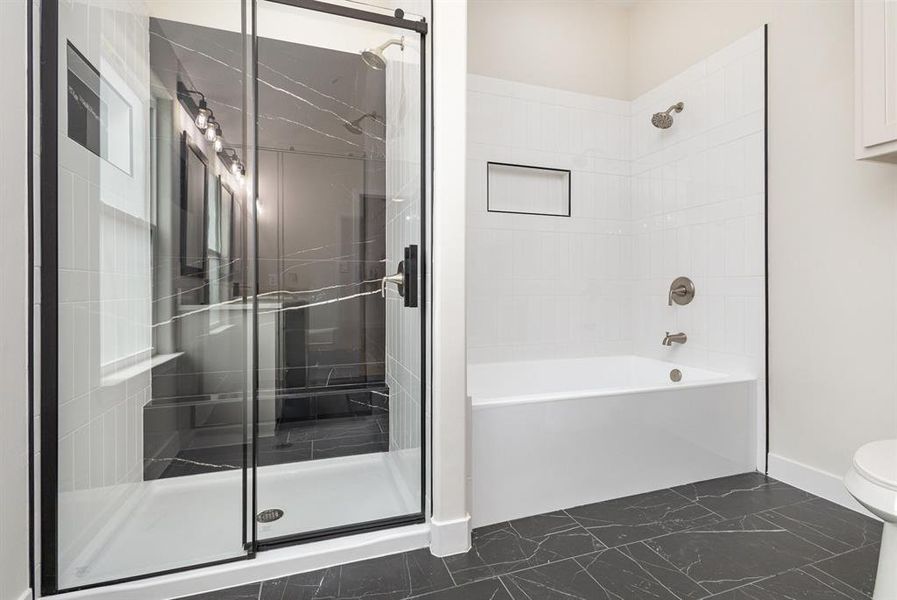 Full bath with toilet, baseboards, marble finish floor, and enclosed tub / shower combo