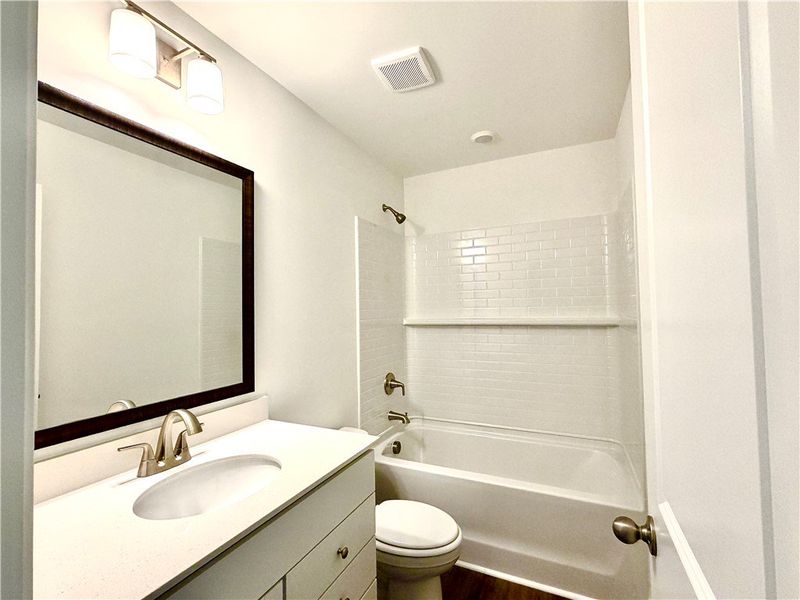 A modern vanity with stone counters complements th