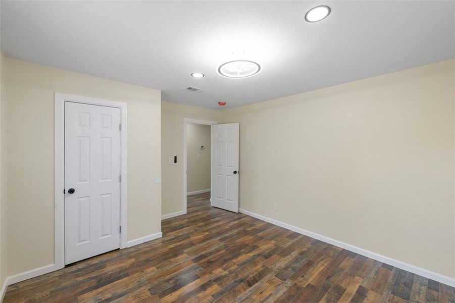 Unfurnished bedroom with hardwood / wood-style floors