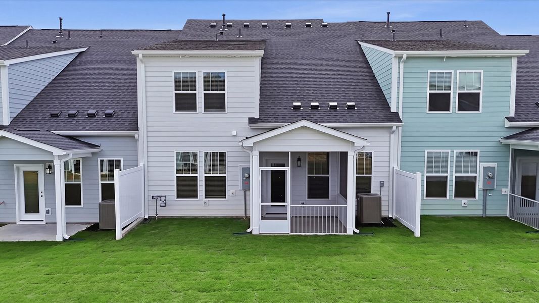 Accomplished exterior with a spacious rear porch that blends comfort and style located at Village at Midway Accomplished exterior with a spacious rear porch that blends comfort and style located at Village at Midway