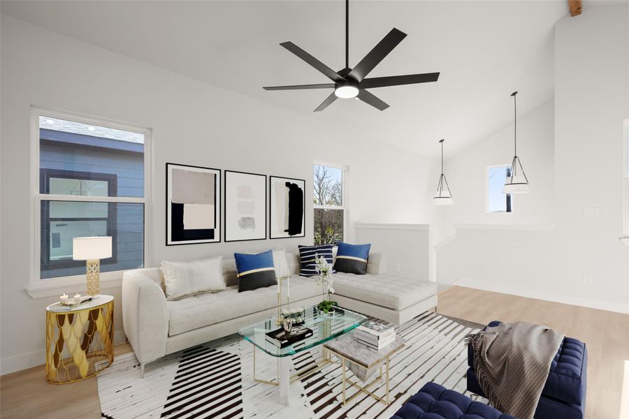 Living room with light wood-style flooring, vaulted ceiling, healthy amount of natural light, and ceiling fan