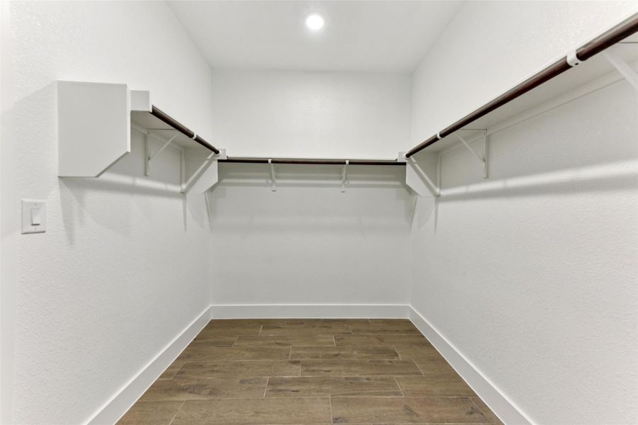 Spacious closet featuring wood tiled floors Spacious closet featuring wood tiled floors