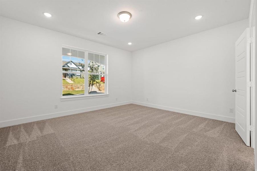 Primary bedroom with carpet