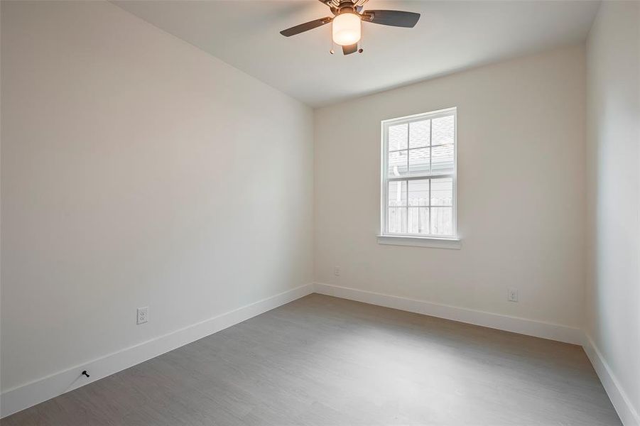 Empty room featuring ceiling fan and hardwood / wood-style floors