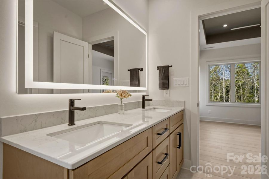 The lighted mirror over the double sink vanity can be dimmed, brightened and the color can be changed. There is another button that gently heats the mirror to prevent fog. There is technology hidden everywhere in this home! The lighted mirror over the double sink vanity can be dimmed, brightened and the color can be changed. There is another button that gently heats the mirror to prevent fog. There is technology hidden everywhere in this home!