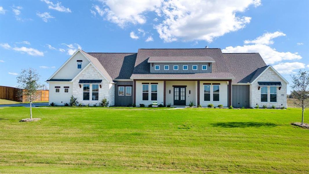 View of front of home with french doors and a front yard