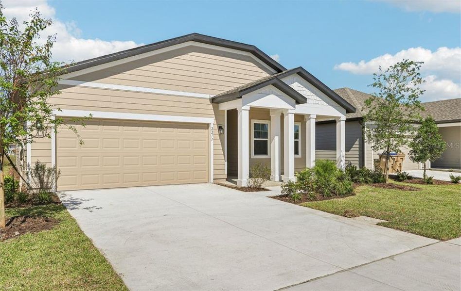 Front exterior of a new home in Ellington Traditional, St. Cloud, FL, highlighting curb appeal (Image 16). Front exterior of a new home in Ellington Traditional, St. Cloud, FL, highlighting curb appeal (Image 16).