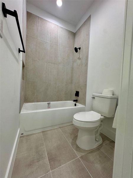 Full bathroom featuring shower combination, tile patterned floors, and recessed lighting Full bathroom featuring shower combination, tile patterned floors, and recessed lighting