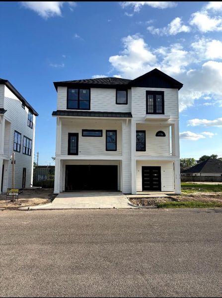 Architectural details such as double glass door entry and wrought iron balconies on the second and third floors.