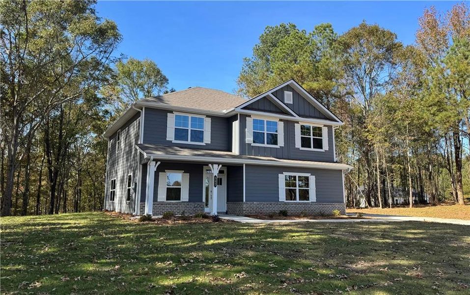 Front exterior of a new home in The Fields of Walnut Creek, Pendergrass, GA, highlighting curb appeal (Image 2). Front exterior of a new home in The Fields of Walnut Creek, Pendergrass, GA, highlighting curb appeal (Image 2).