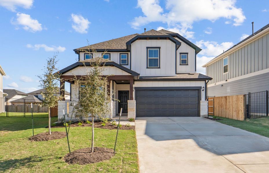 Front exterior of a new home in Santa Rita Ranch, Liberty Hill, TX, highlighting curb appeal (Image 24). Front exterior of a new home in Santa Rita Ranch, Liberty Hill, TX, highlighting curb appeal (Image 24).