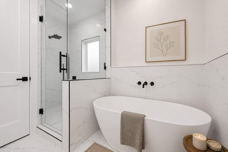 Primary ensuite with soaking tub and walk in shower. Photo is virtually staged