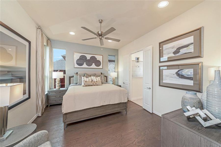 Spacious bedroom featuring wood-finish flooring, recessed lighting, and a ceiling fan