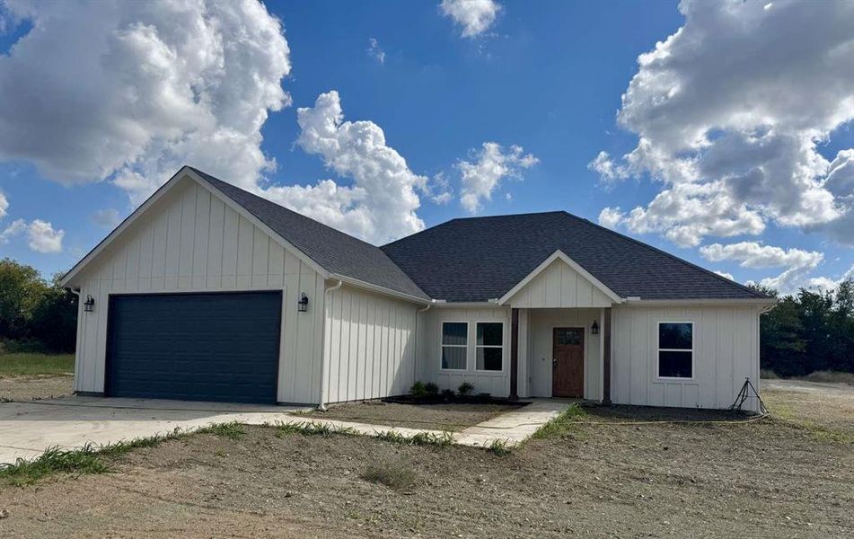 View of front of home featuring a shingled roof, an attached garage, concrete driveway, and board and batten siding View of front of home featuring a shingled roof, an attached garage, concrete driveway, and board and batten siding