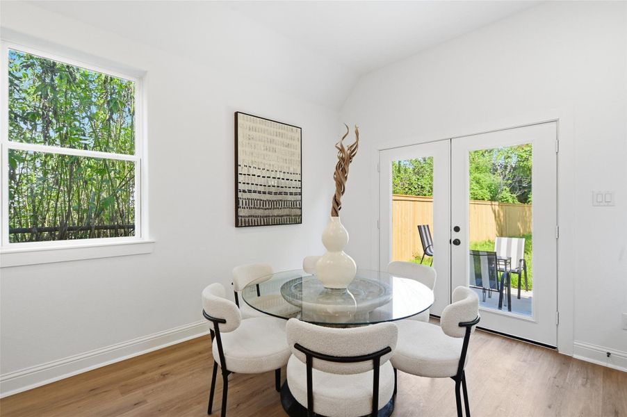 Open concept kitchen, dining and living room, with lots of natural light.