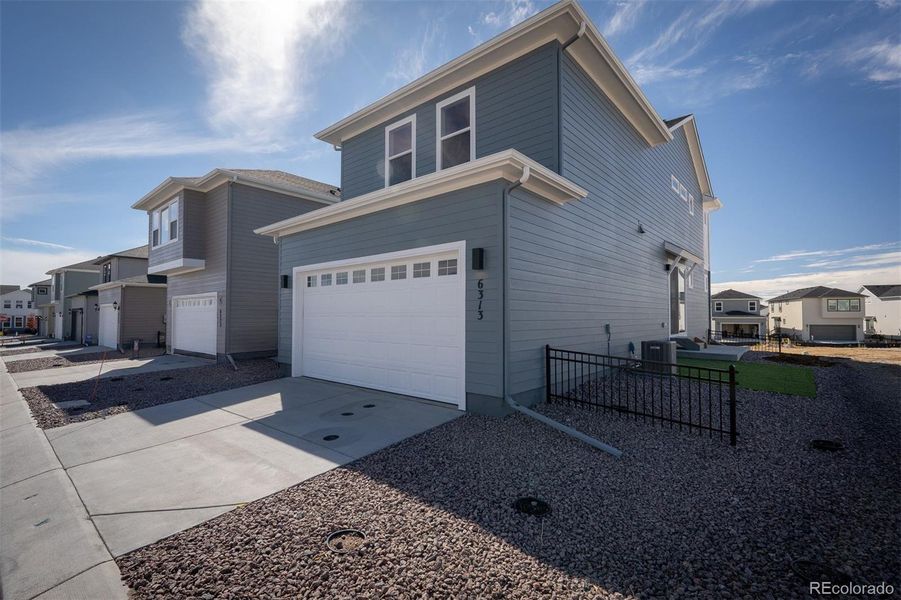 Exterior details and patio area of a home in Revel Crossing at Wolf Ranch – The Ascent Collection, Colorado Springs (Image 2).