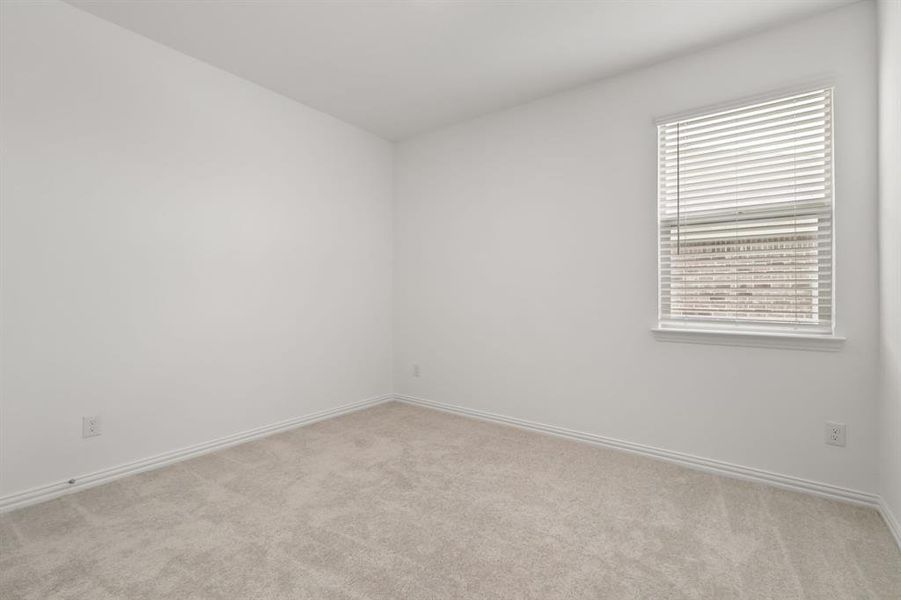 Spare room featuring light carpet