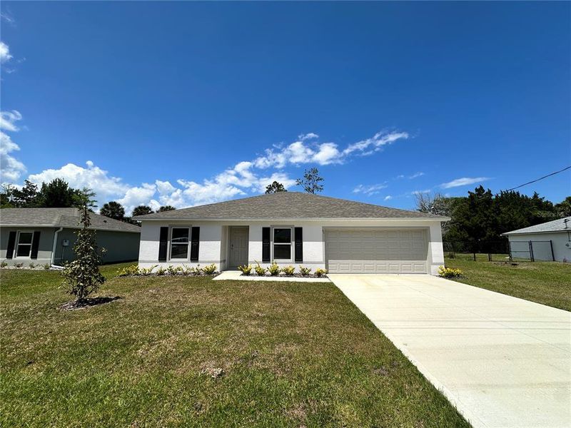 Front exterior of a new home in Palm Coast, Palm Coast, FL, highlighting curb appeal (Image 1). Front exterior of a new home in Palm Coast, Palm Coast, FL, highlighting curb appeal (Image 1).