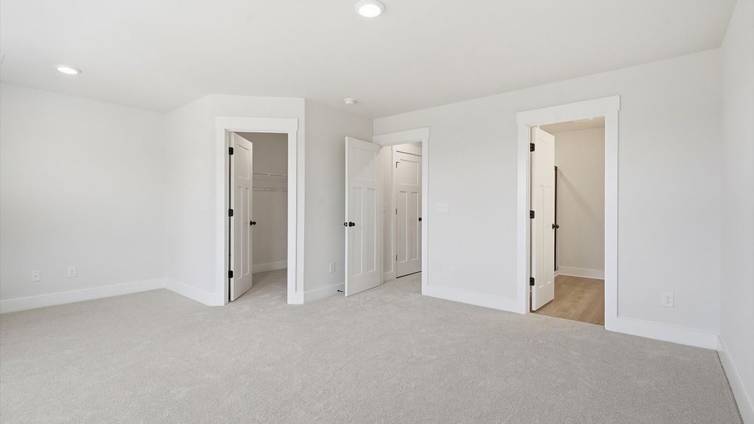 Eye-catching details and elegant finishes in the vibrant primary suite of this select home
