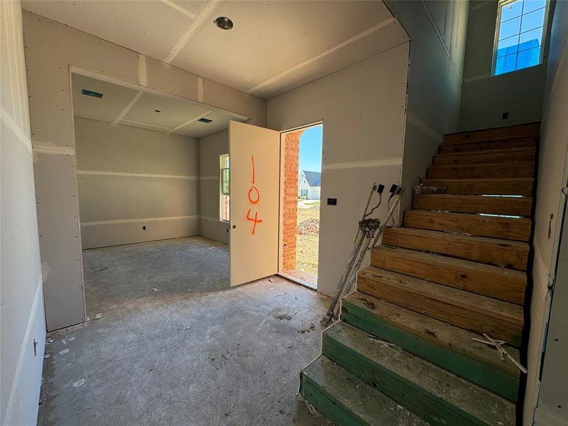 Stairs featuring concrete flooring