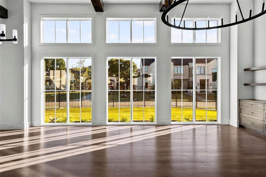 Doorway with wood finished floors, a chandelier, and a high ceiling Doorway with wood finished floors, a chandelier, and a high ceiling