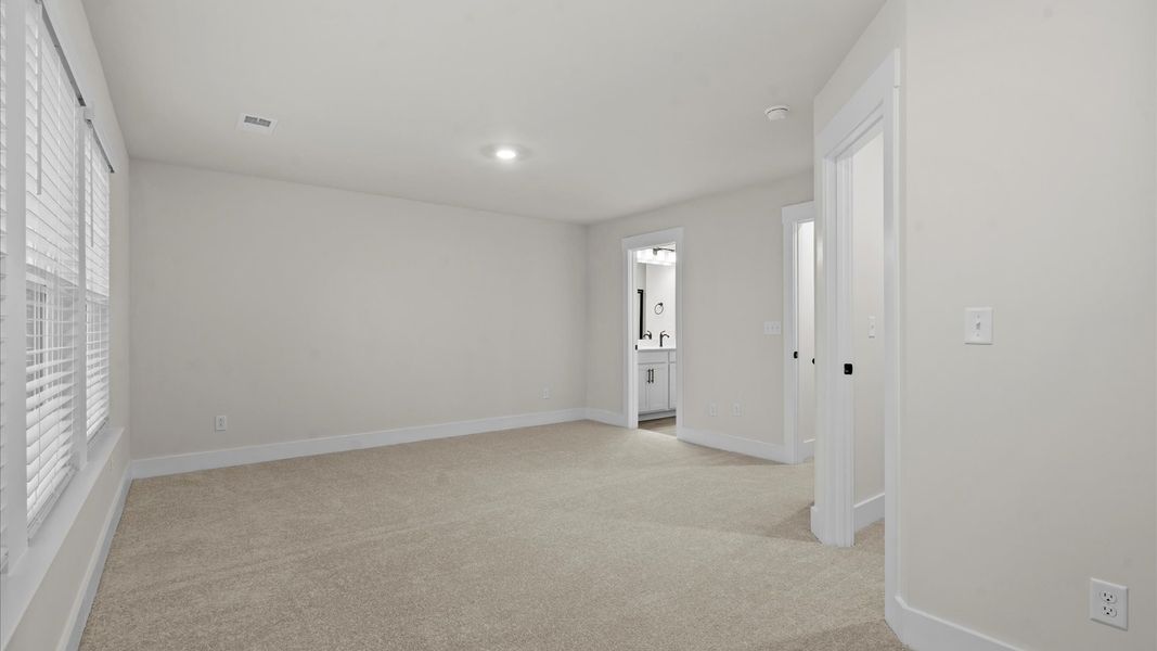 Vibrant natural light fills this exceptional primary suite with eye-catching details