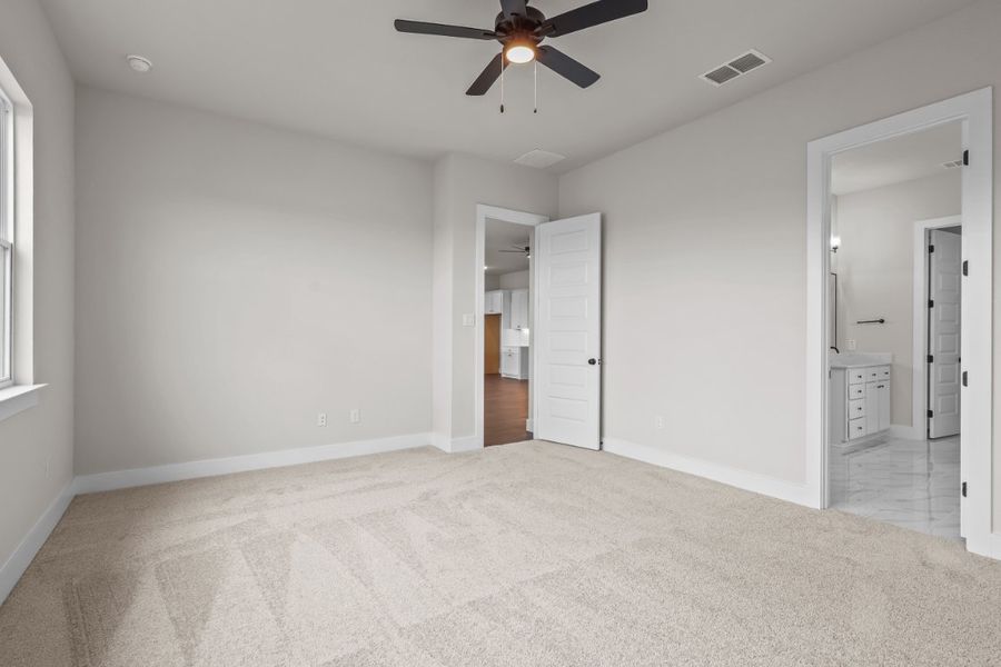 A room with a ceiling fan and a door. A room with a ceiling fan and a door.