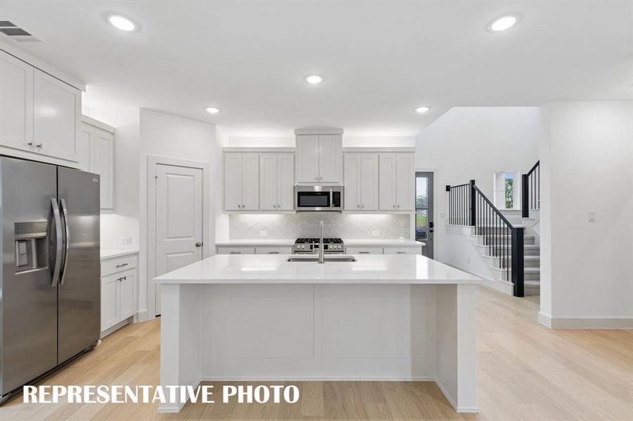 The spacious kitchen island is the hub of your new dream kitchen offering the perfect gathering space for friends and family.  REPRESENTATIVE PHOTO