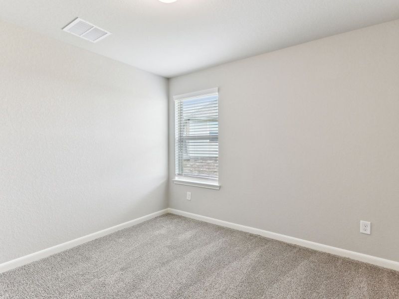 Guest bedroom in the Matador floorplan at a Meritage Homes community.