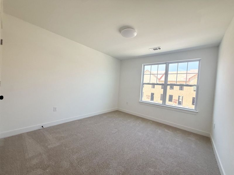 Carpeted spare room with baseboards