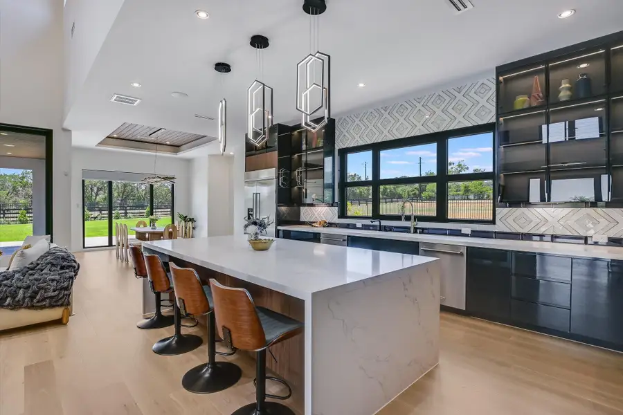 Kitchen featuring dishwasher, a kitchen island, modern cabinets, light wood flooring Kitchen featuring dishwasher, a kitchen island, modern cabinets, light wood flooring