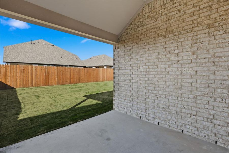 Fenced yard featuring a patio area Fenced yard featuring a patio area